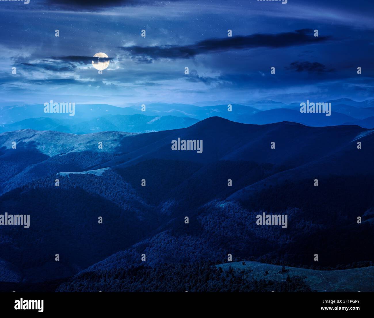 mysterious mountain landscape in summer at night. travel ukraine background. full moon over rolling hill in dappled light. scenic view of borzhava rid Stock Photo