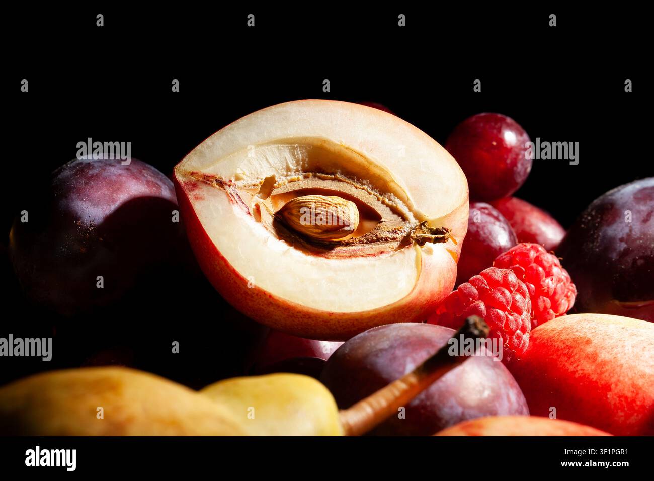 sliced white nectarine fruit mix on black background Stock Photo