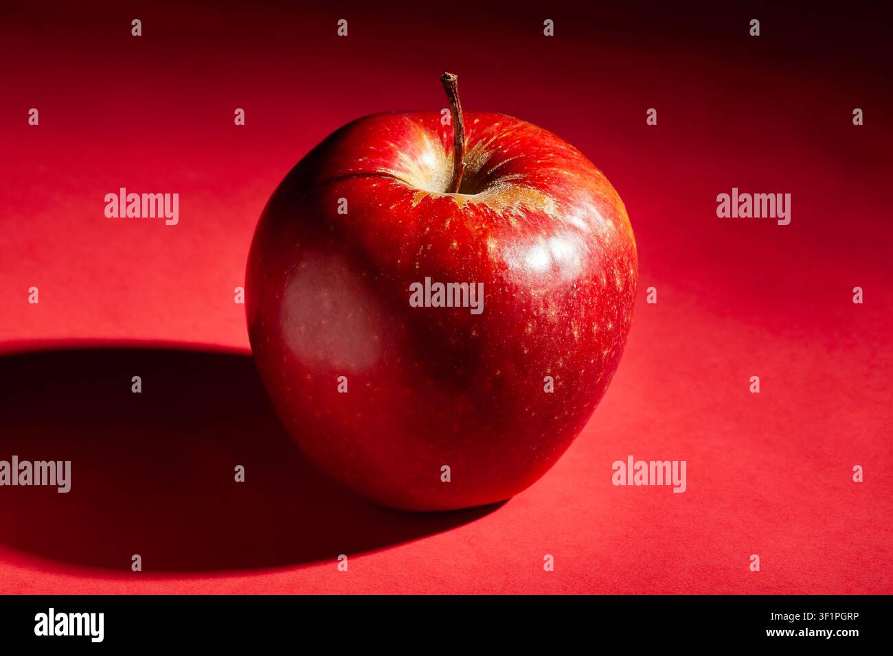 red apple on red background Stock Photo