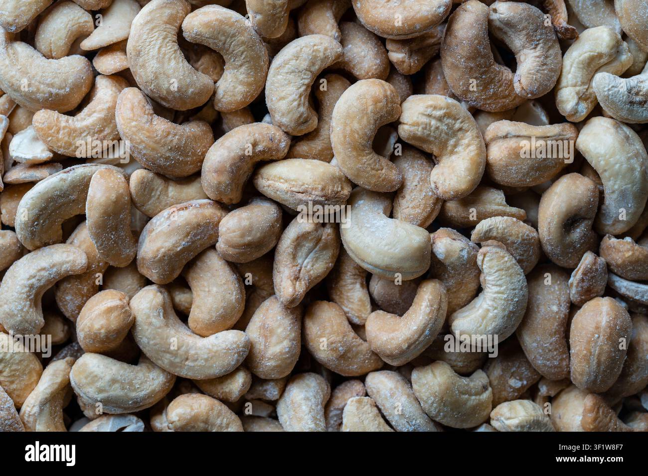 Pile cashew nuts without shell, close up, top view. Whole nut kernels Stock Photo