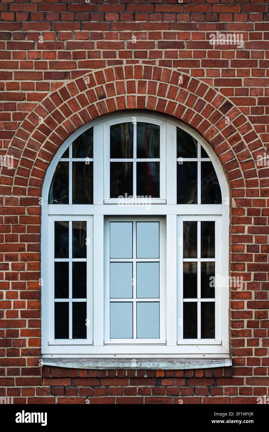Traditional White Arched Window on Red Brick Wall Facade Stock Photo