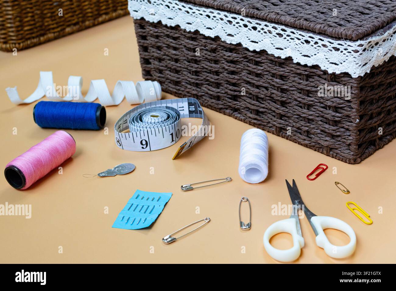 Sewing Supplies and Tailoring Tools Arranged on Workspace Table Stock Photo