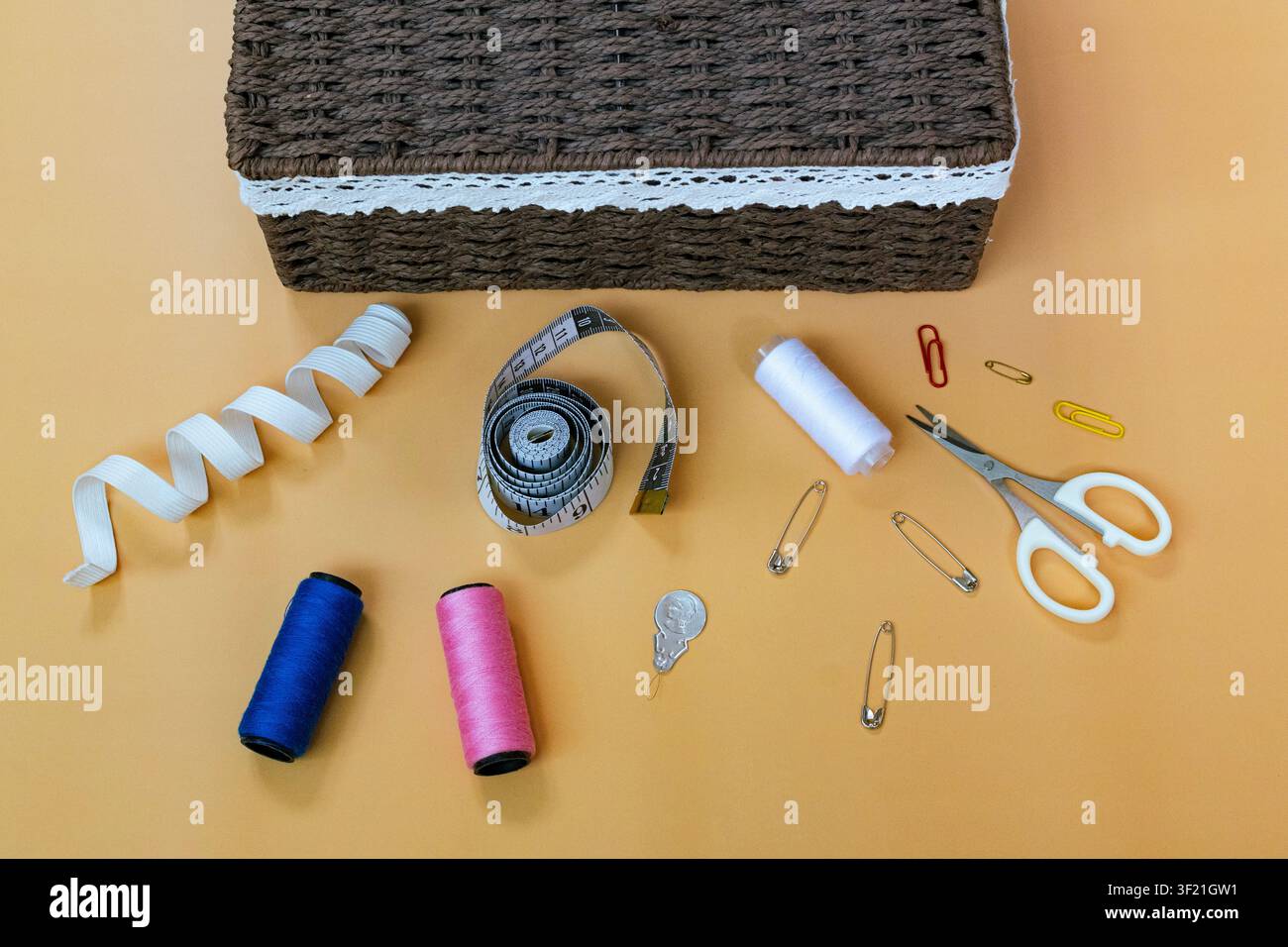 Sewing Supplies and Tailoring Tools Arranged on Workspace Table Stock Photo