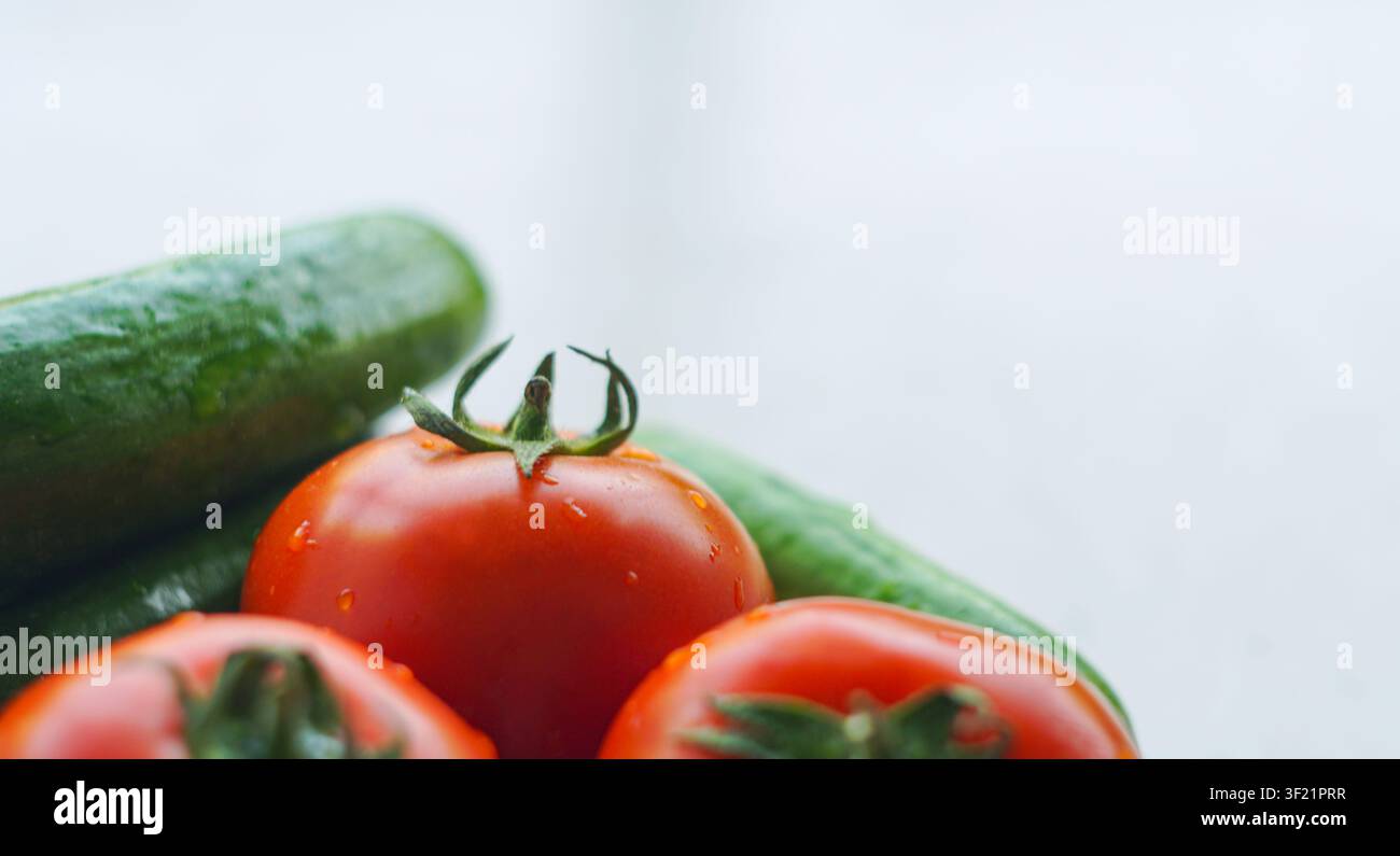 Cucumbers and tomatoes on a white background Stock Photo