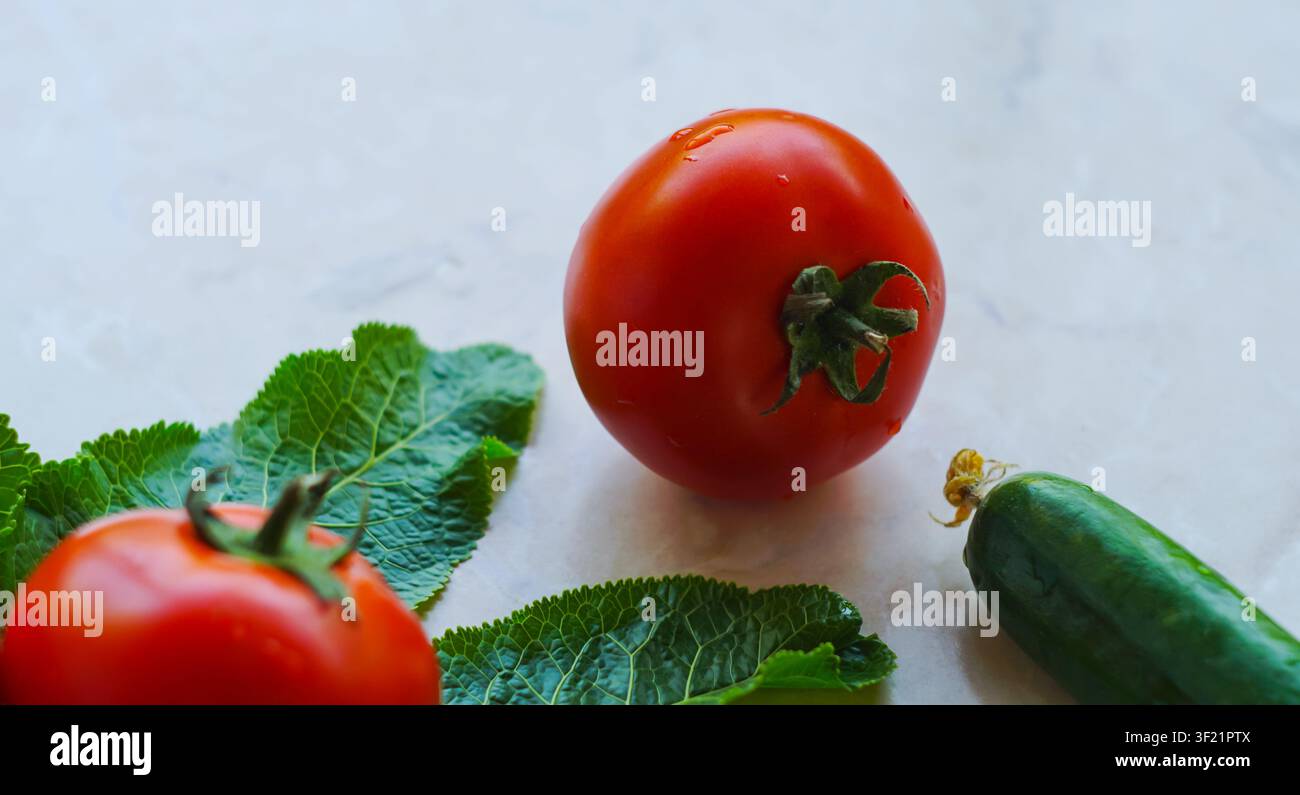 Cucumbers and tomatoes on a white background Stock Photo