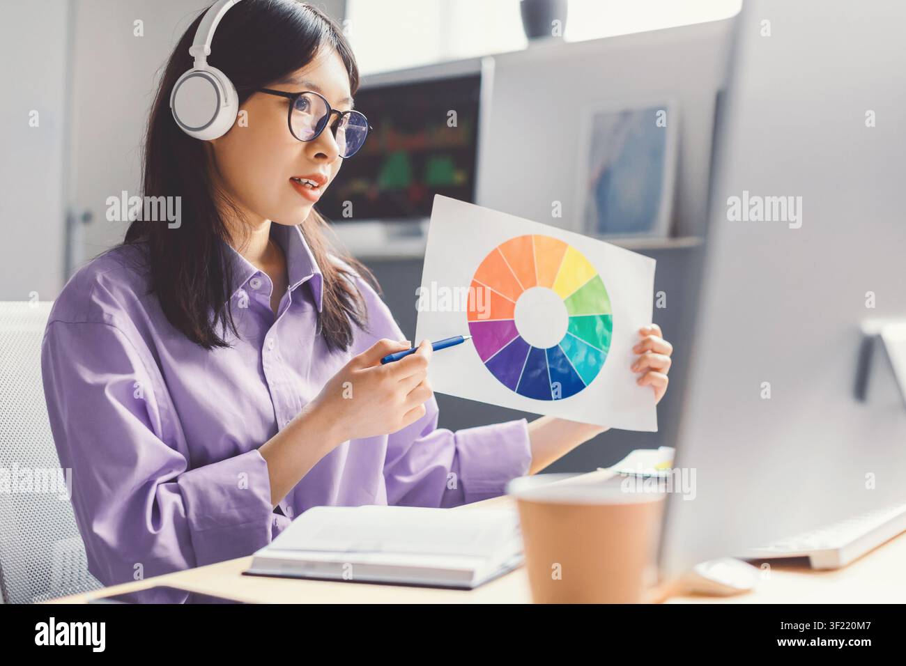 Female Asian Design Student Presenting Color Wheel At Home Office, Creative Concept Stock Photo