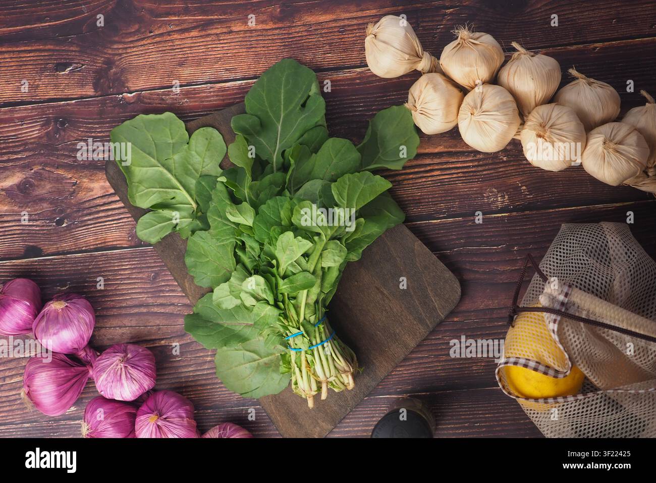 Fresh vegetables on a wooden surface in a kitchen Stock Photo
