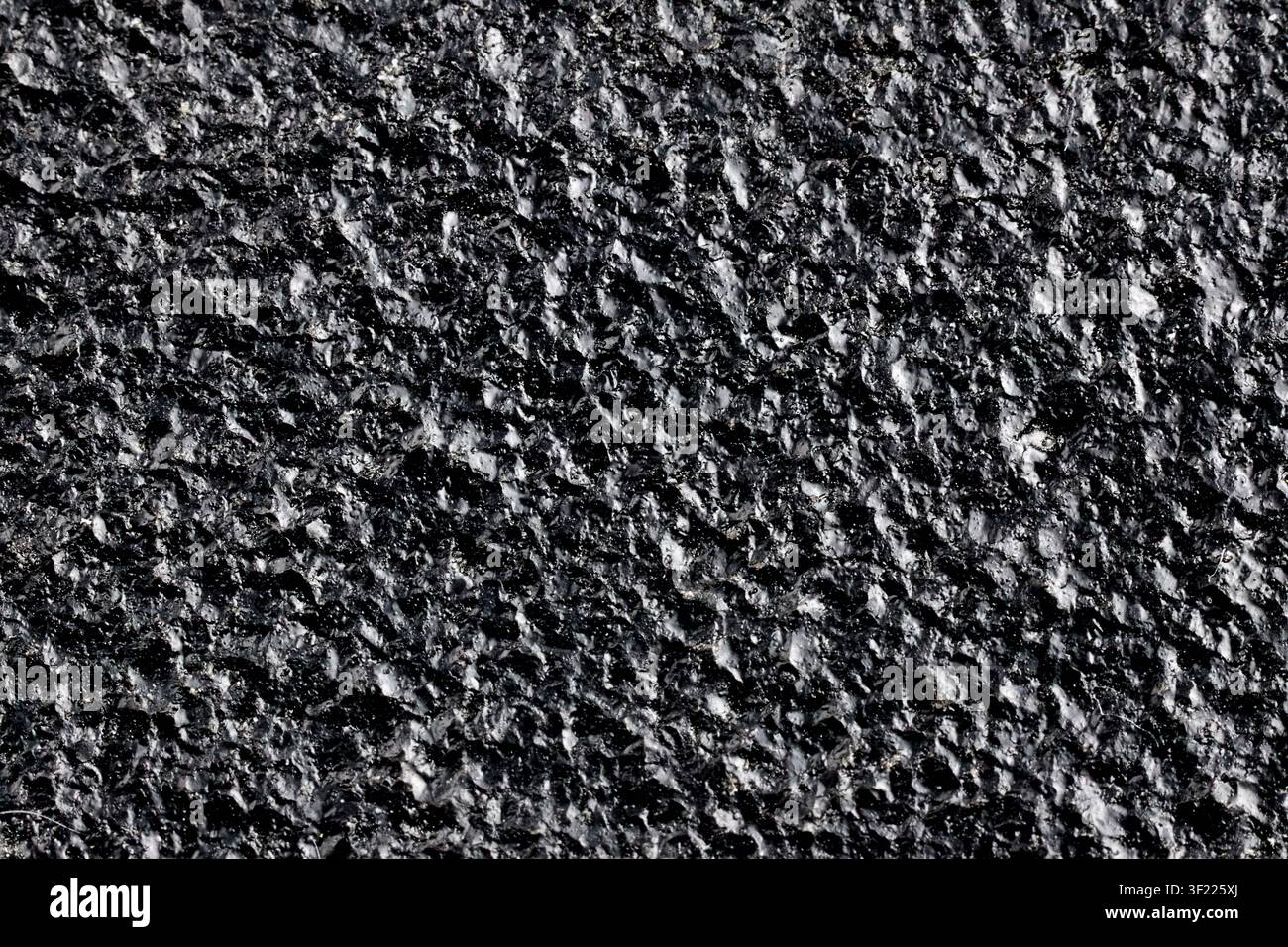 Black painted cast iron texture surface background macro close up rough metallic material dark backdrop pattern, structure industrial solid gritty coa Stock Photo