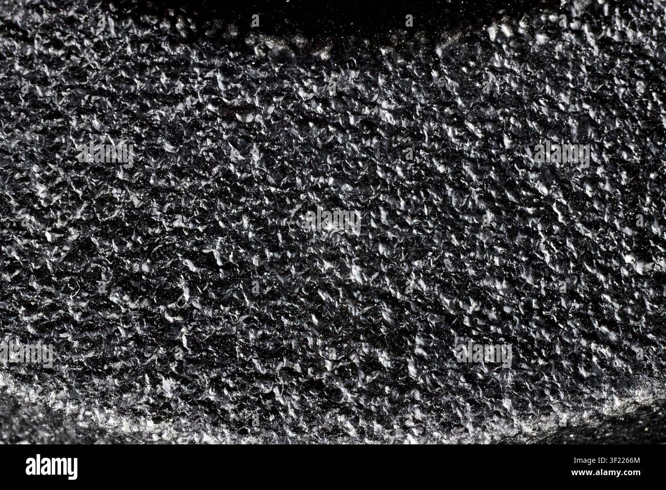 Black painted cast iron texture surface background macro close up rough metallic material dark backdrop pattern, structure industrial solid gritty coa Stock Photo
