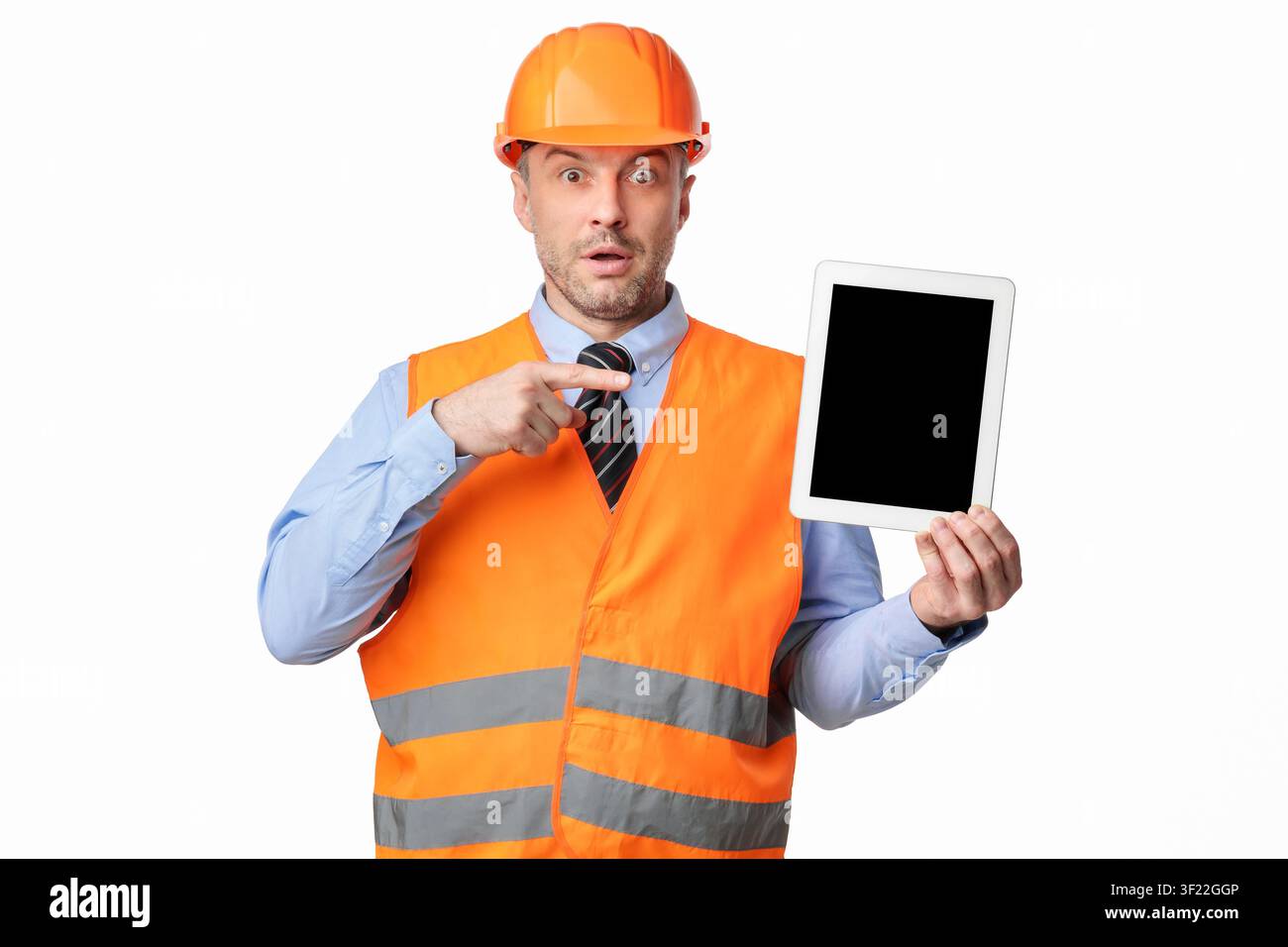 Surprised Worker Man Showing Tablet Screen On White Studio Background Stock Photo