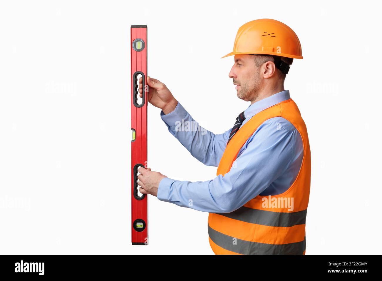 Construction Site Worker Using Builder's Level Working Over White Background Stock Photo