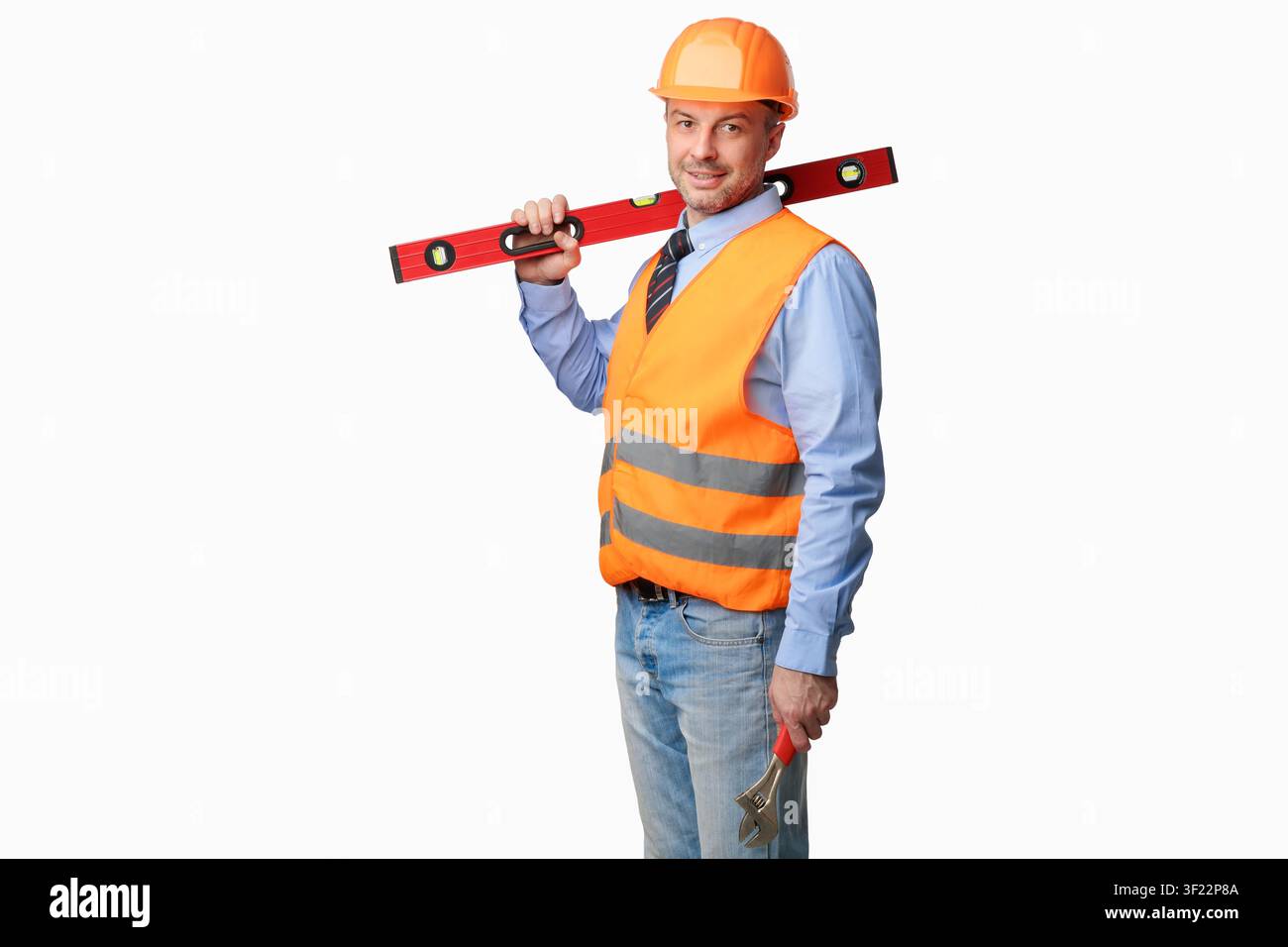 Worker Man Posing With Builder's Level Standing In Studio Stock Photo