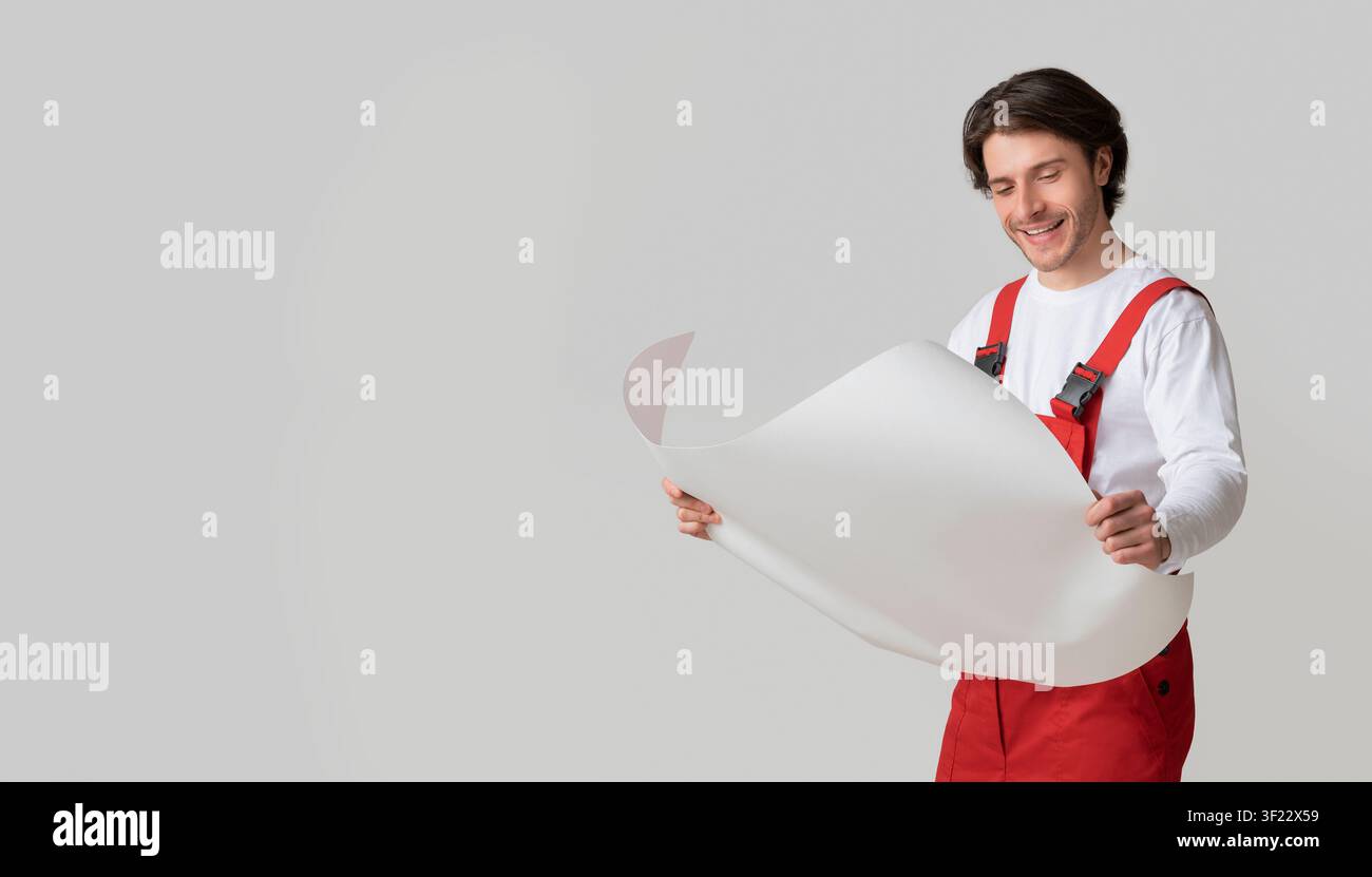Repairing Worker Checking Blueprint, Holding Project Plan In Hands And Smiling Stock Photo