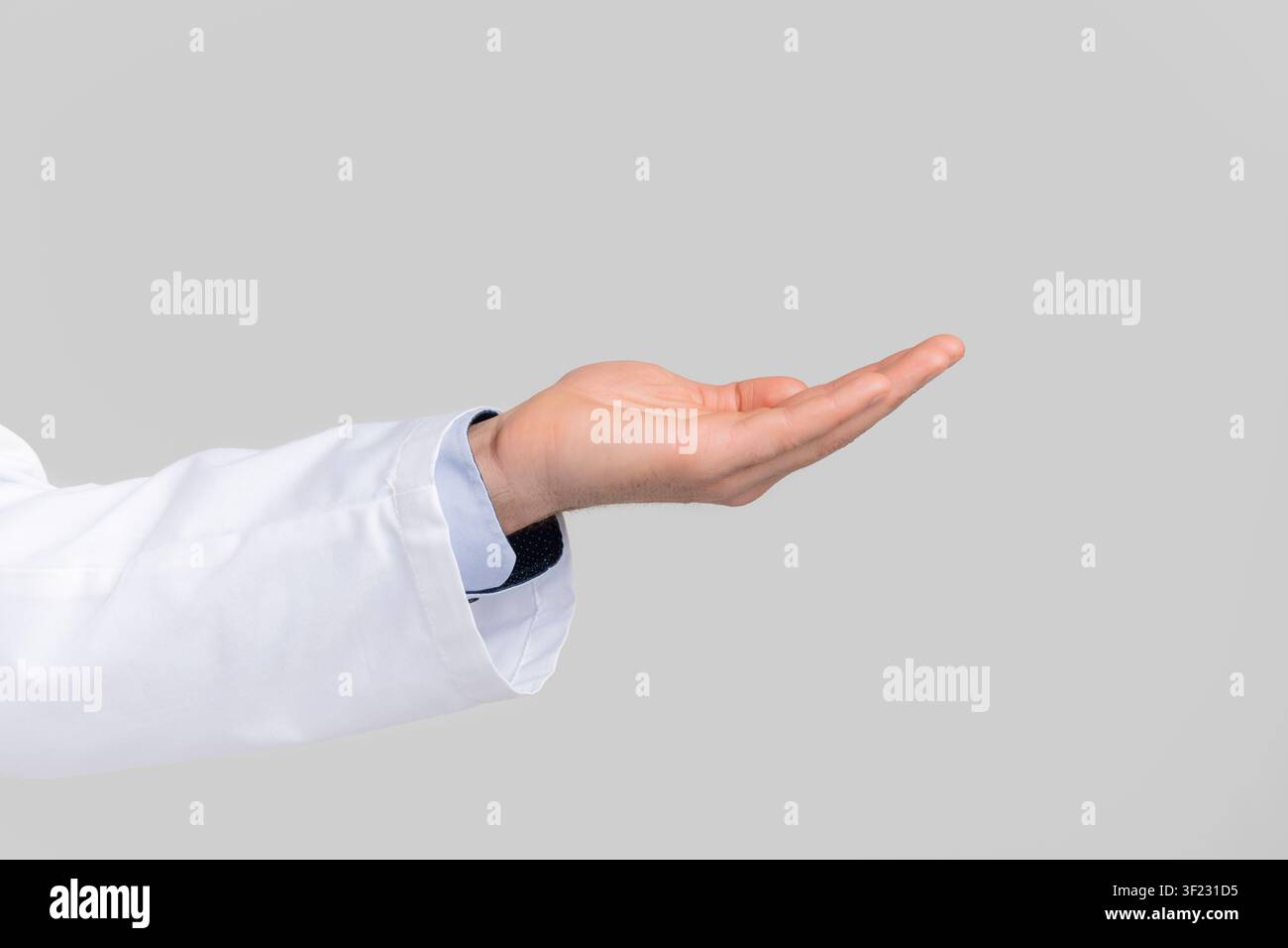 Male doctor's hand ponting or holding virtual object on open palm Stock Photo