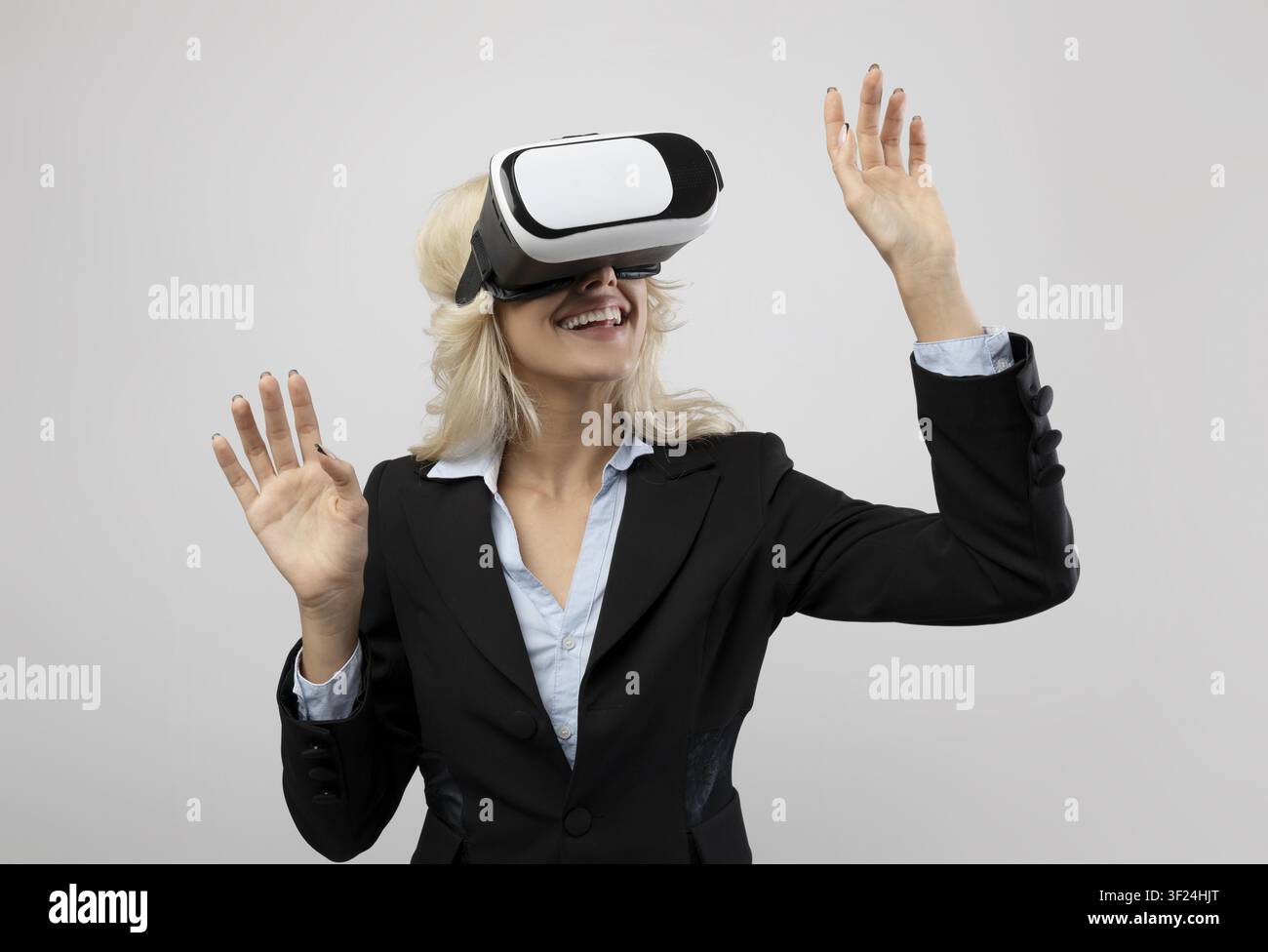 Happy Young Caucasian Woman Wearing Vr Headset Experiencing Virtual Reality, Office Setting Stock Photo