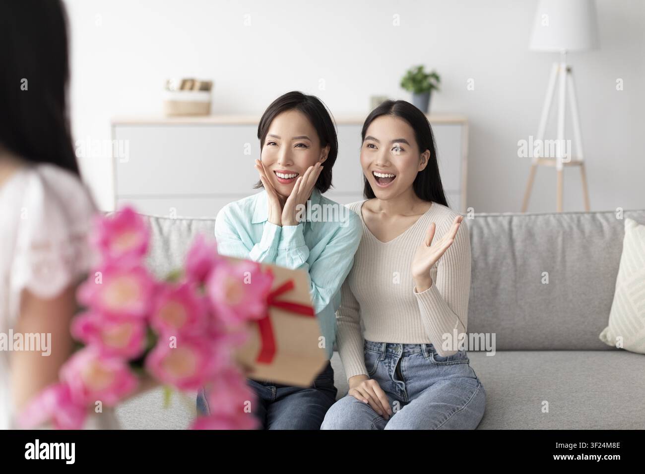 Happy Asian Women Surprised With Gift Box At Home, Excited Celebration Moment Stock Photo