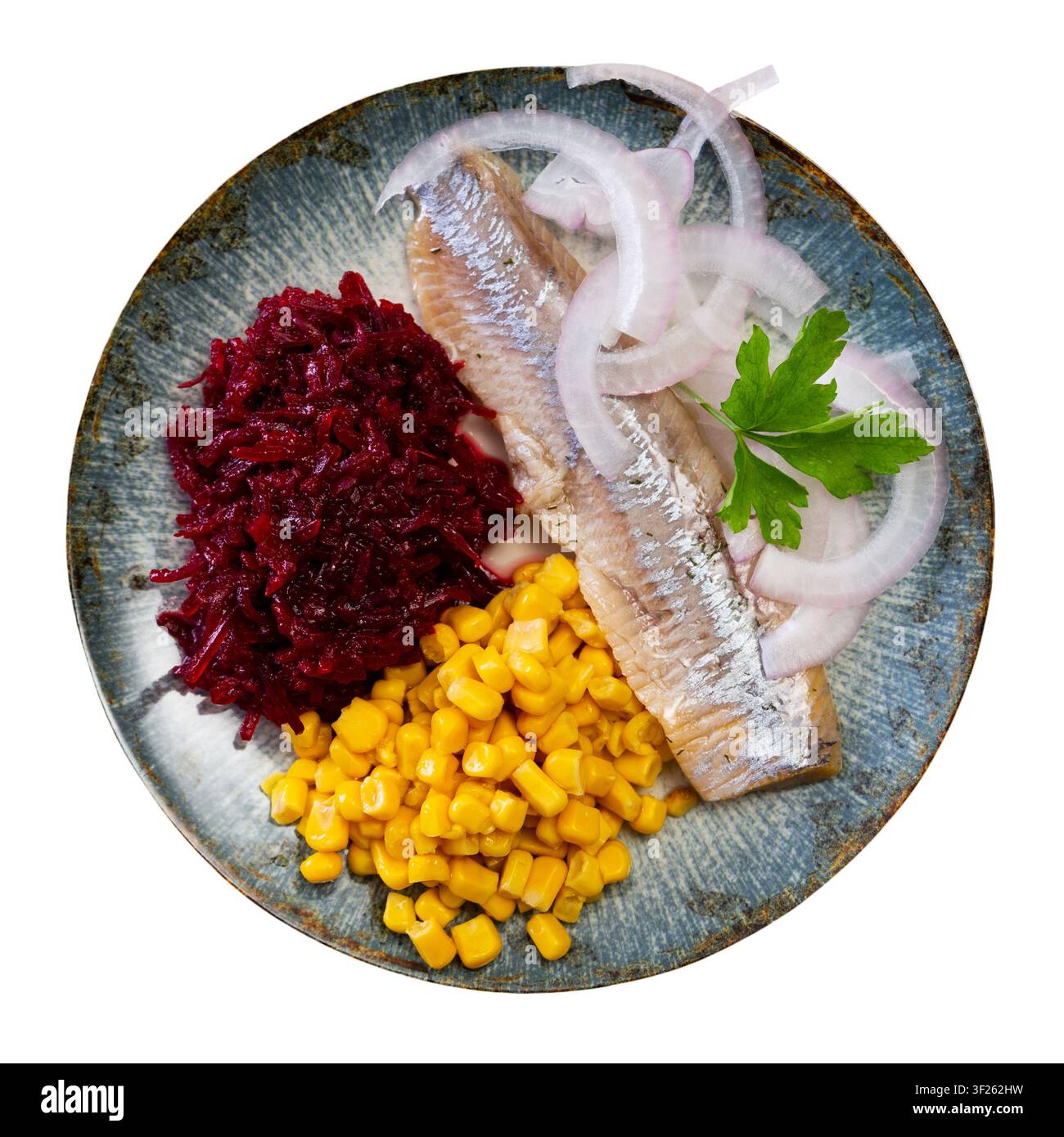 Herring served on plate with grated beetroot and corn Stock Photo