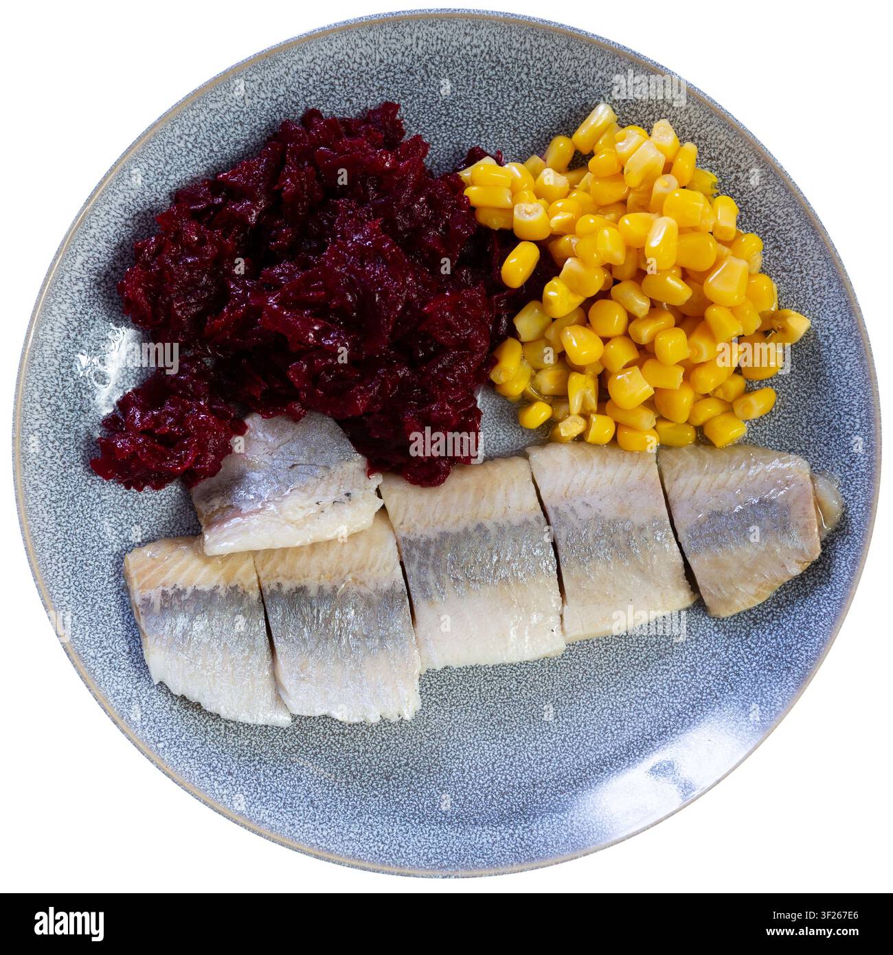 Herring served on plate with grated beetroot and corn Stock Photo