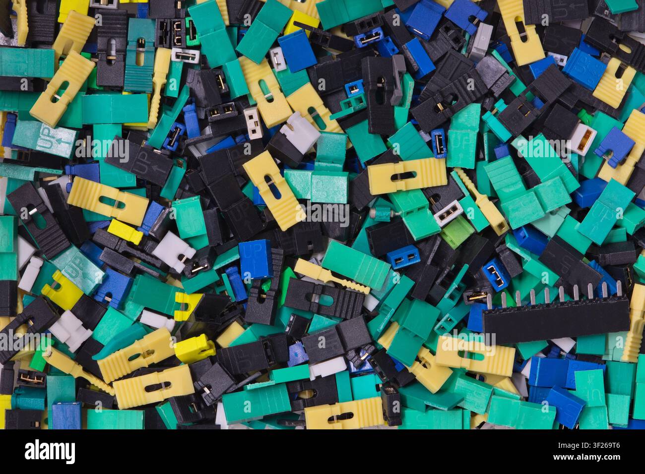 Circuit board jumper caps plastic computer components scattered loosely. Stock Photo