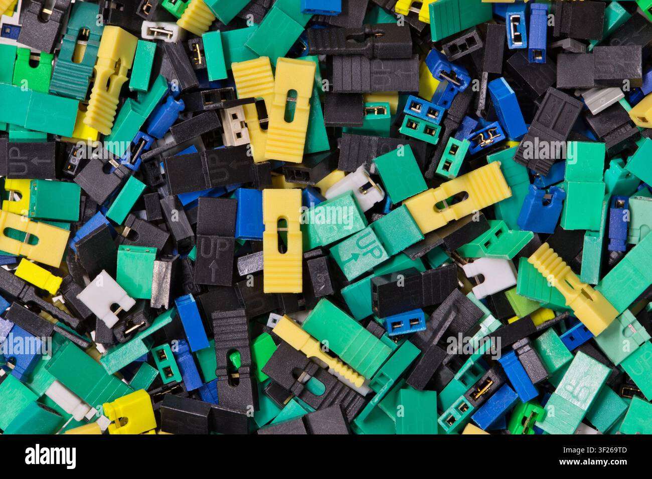 Circuit board jumper caps plastic computer components scattered loosely. Stock Photo