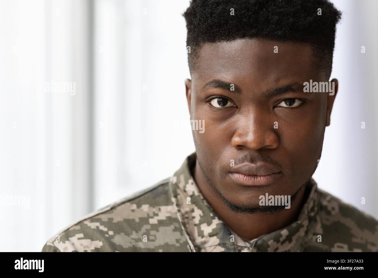 Serious Young Black Male In Military Jacket Looking Confident With Intent Focused Expression Stock Photo