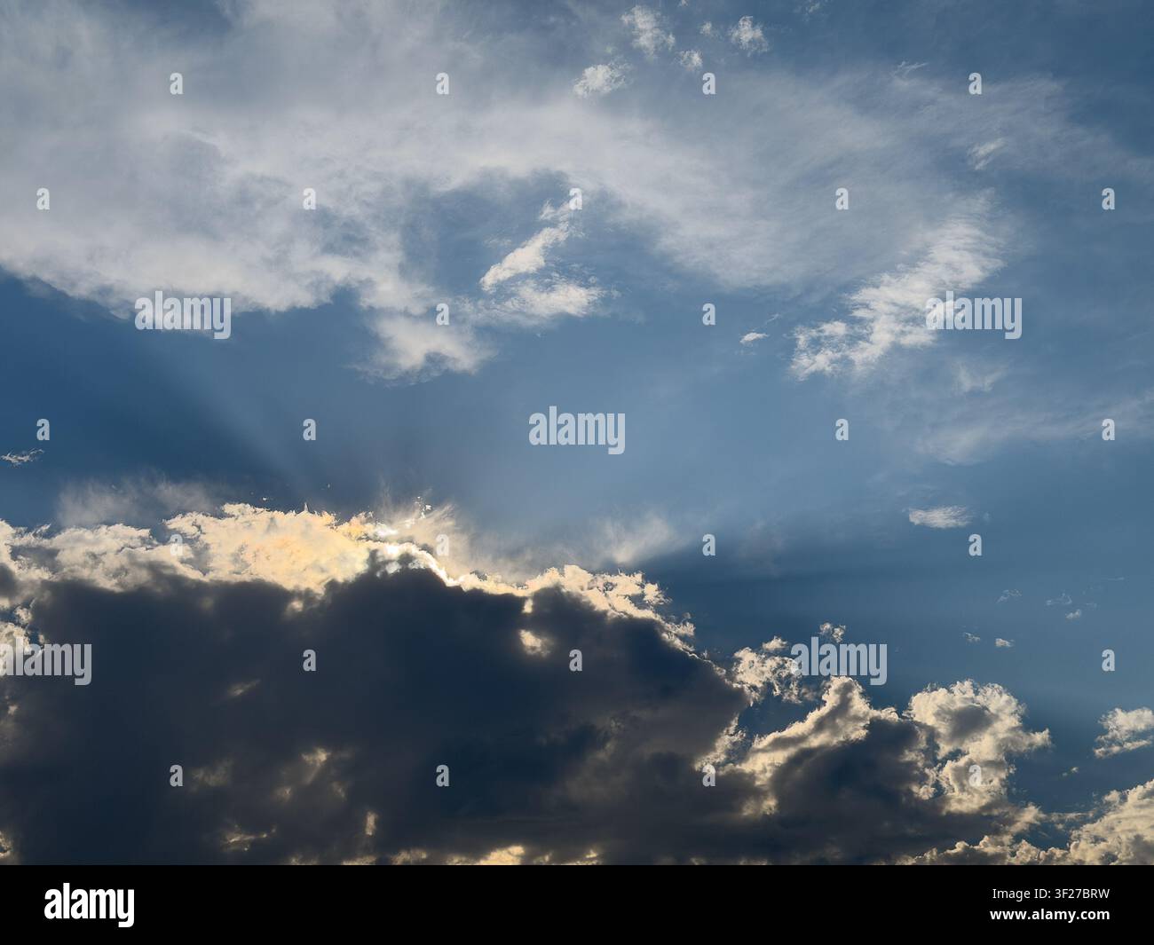 Sun rays breaking through dramatic clouds above the Pacific Northwest sky. Stock Photo