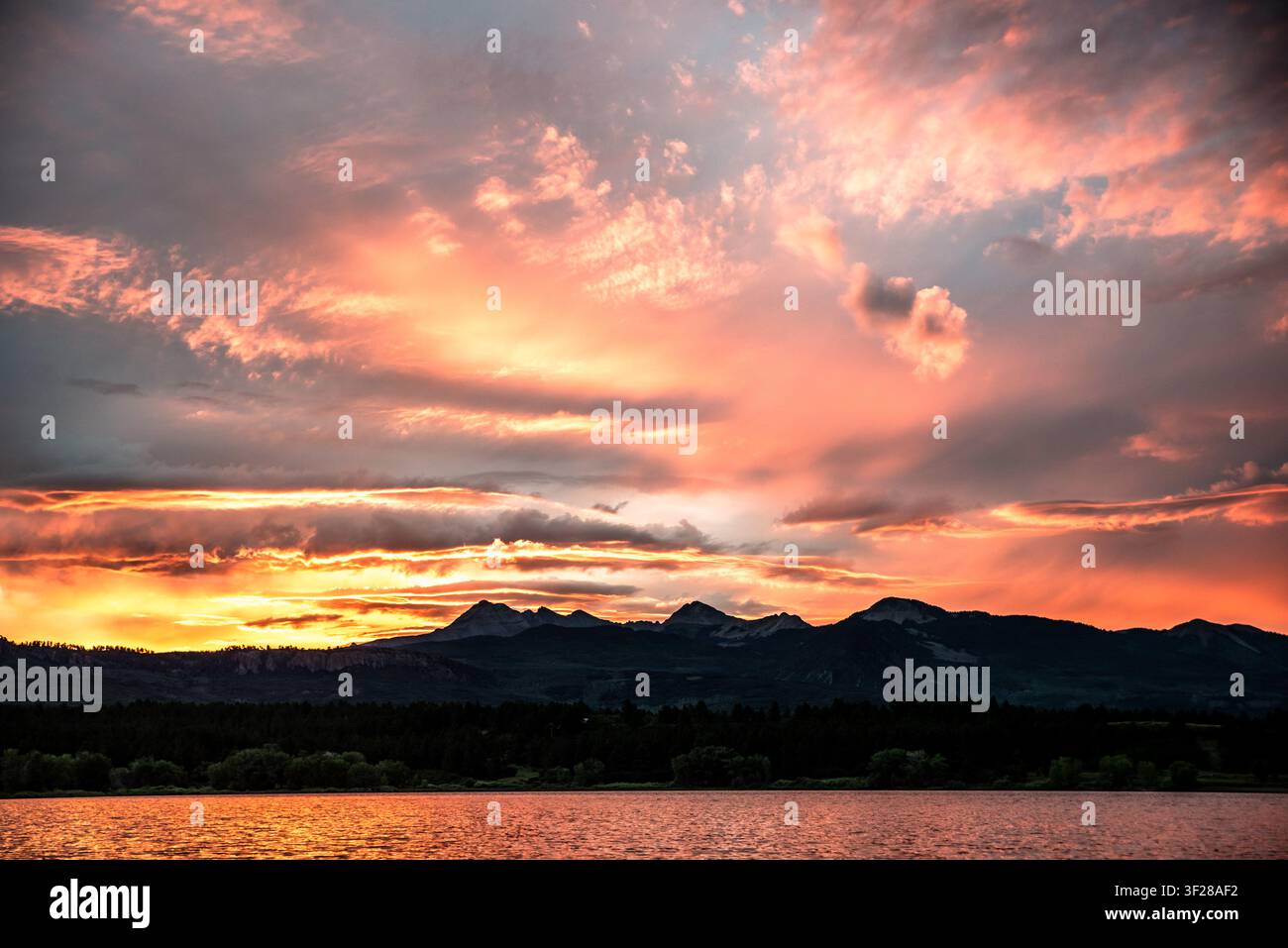 Fiery pink and orange sunset over mountains Stock Photo