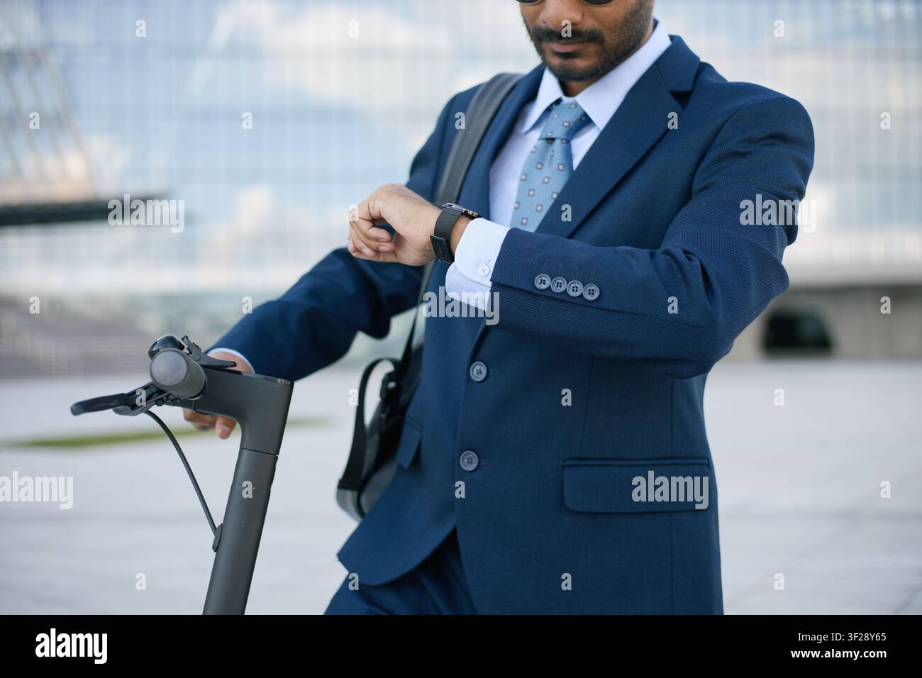 Indian Businessman Checking Smartwatch While Commuting to Work Stock Photo