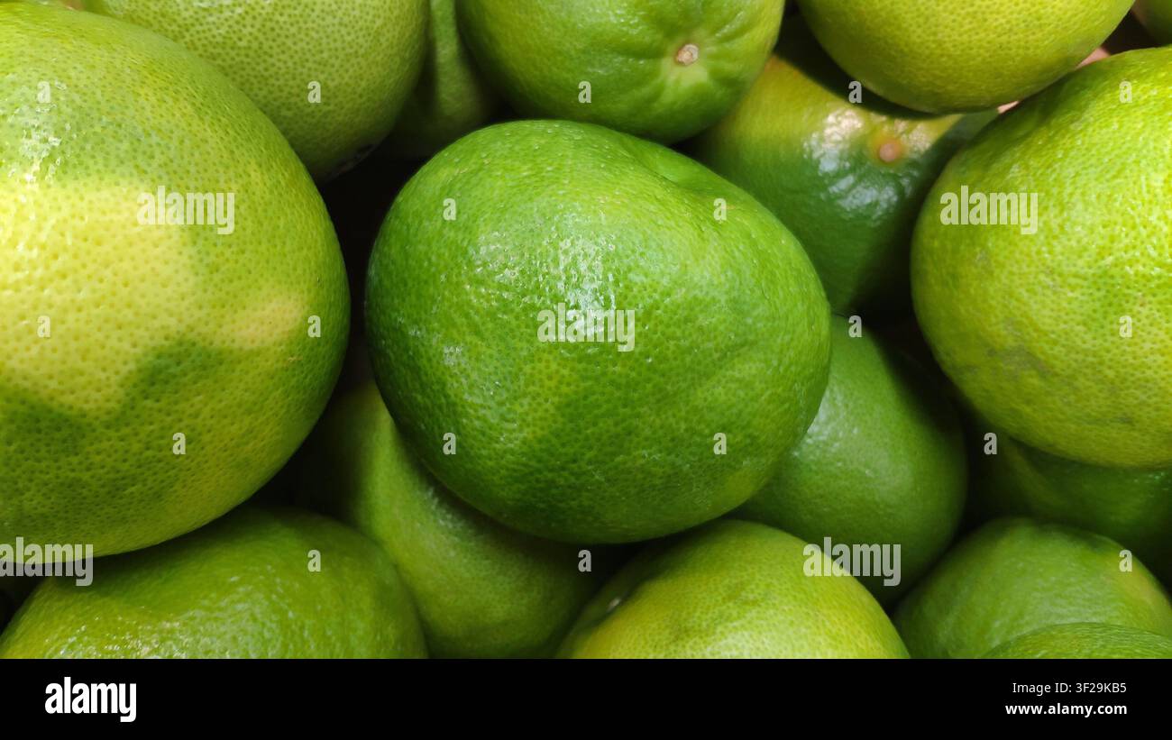 Fresh green lime fruits background close up Stock Photo