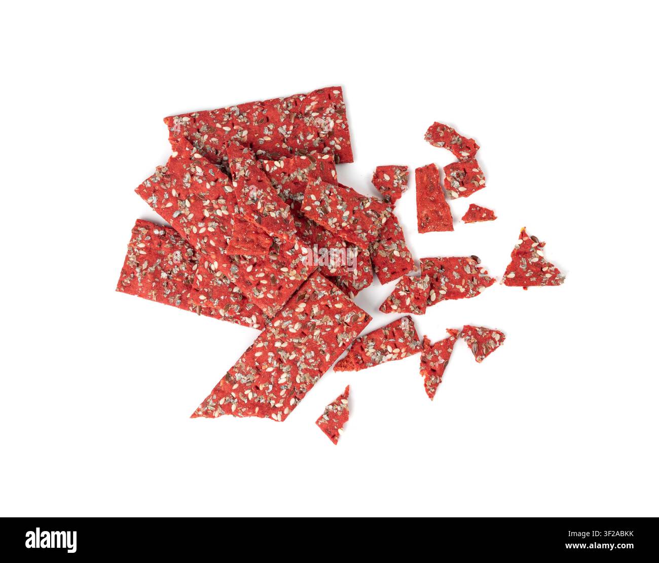 Beetroot crackers pieces isolated, crumbled thin rusk beet root bread pile, broken red diet multigrain crispbread with various seeds, crisp bread, lon Stock Photo