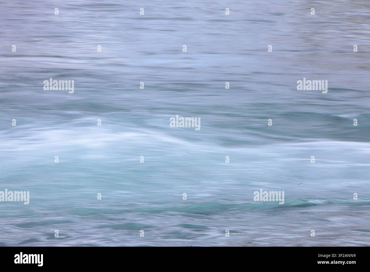 water in motion creates an interesting background, blurred with camera motion. Stock Photo