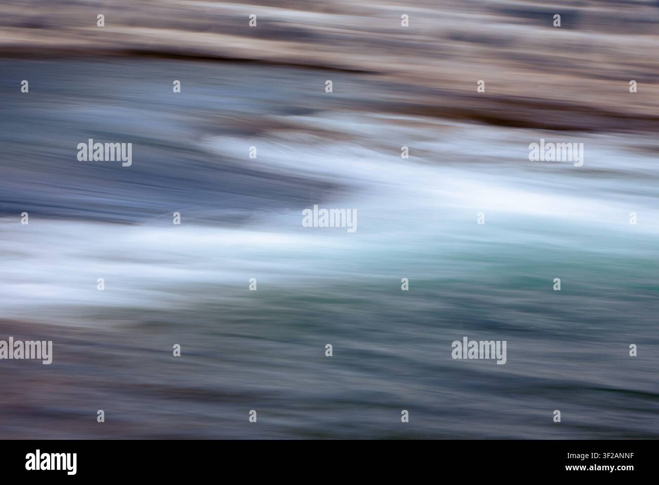 water in motion creates an interesting background, blurred with camera motion. Stock Photo