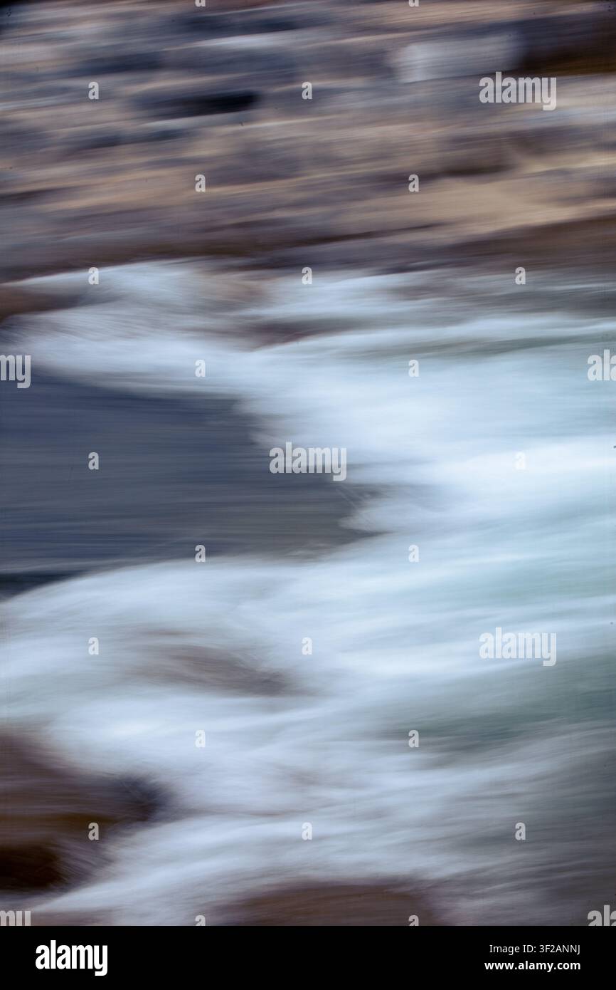 water in motion creates an interesting background, blurred with camera motion. Stock Photo