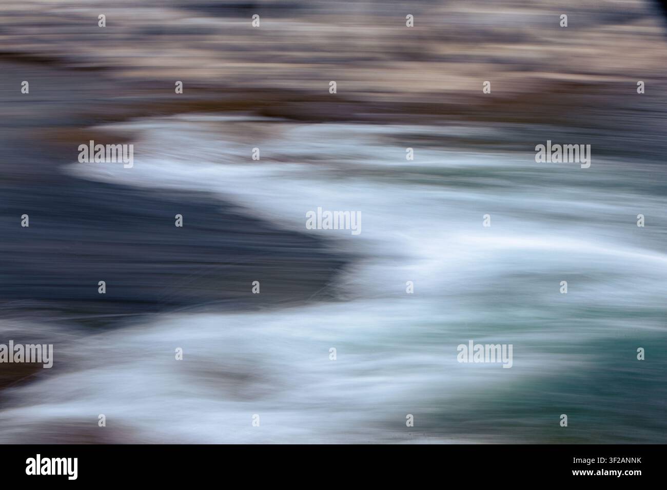 water in motion creates an interesting background, blurred with camera motion. Stock Photo