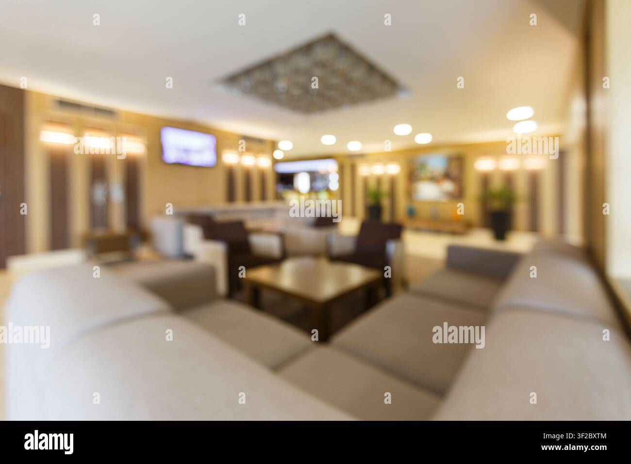 Blurred photo of hotel lobby with big heart corner sofa Stock Photo