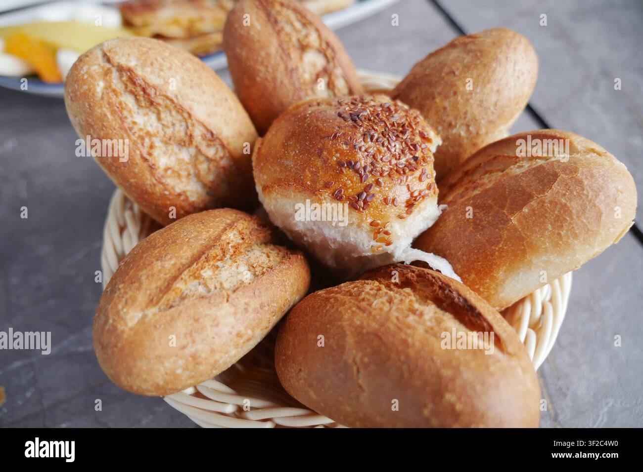 Fresh bread rolls in a basket at a local bakery Stock Photo