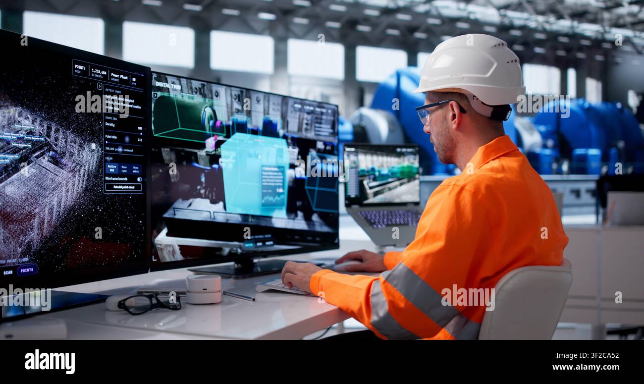 Young Engineer Monitors Real-time Industrial Data On Smart Control Room Screens. Stock Photo