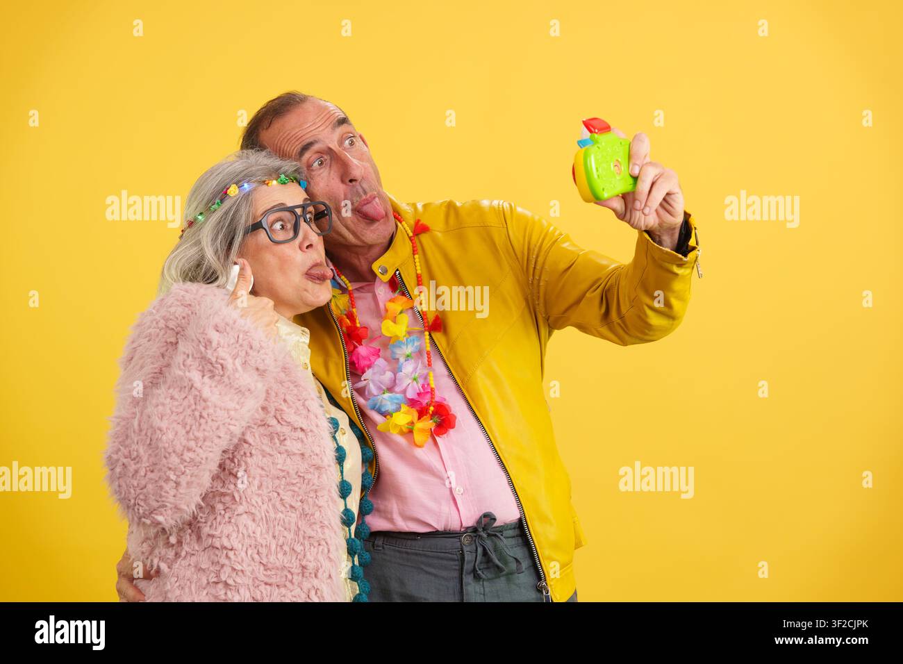 Cheerful mature couple making funny faces capturing a selfie Stock Photo