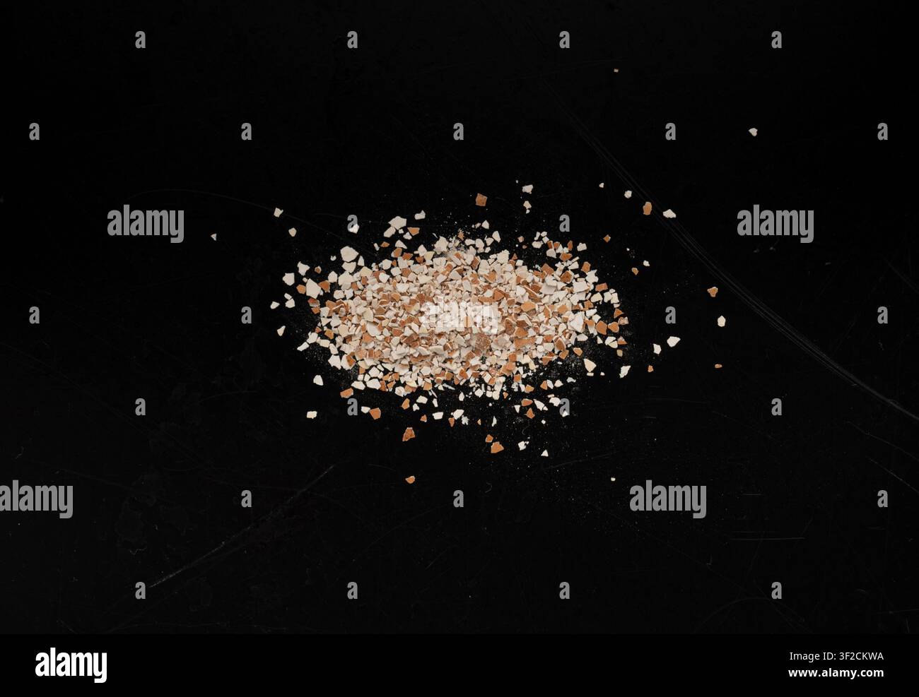 Broken Egg Shell Isolated, Crushed Eggshell, Calcium Supplement, Cracked Eggshells, Natural Compost Ingredient, Broken Egg Shells Pile on Black Backgr Stock Photo