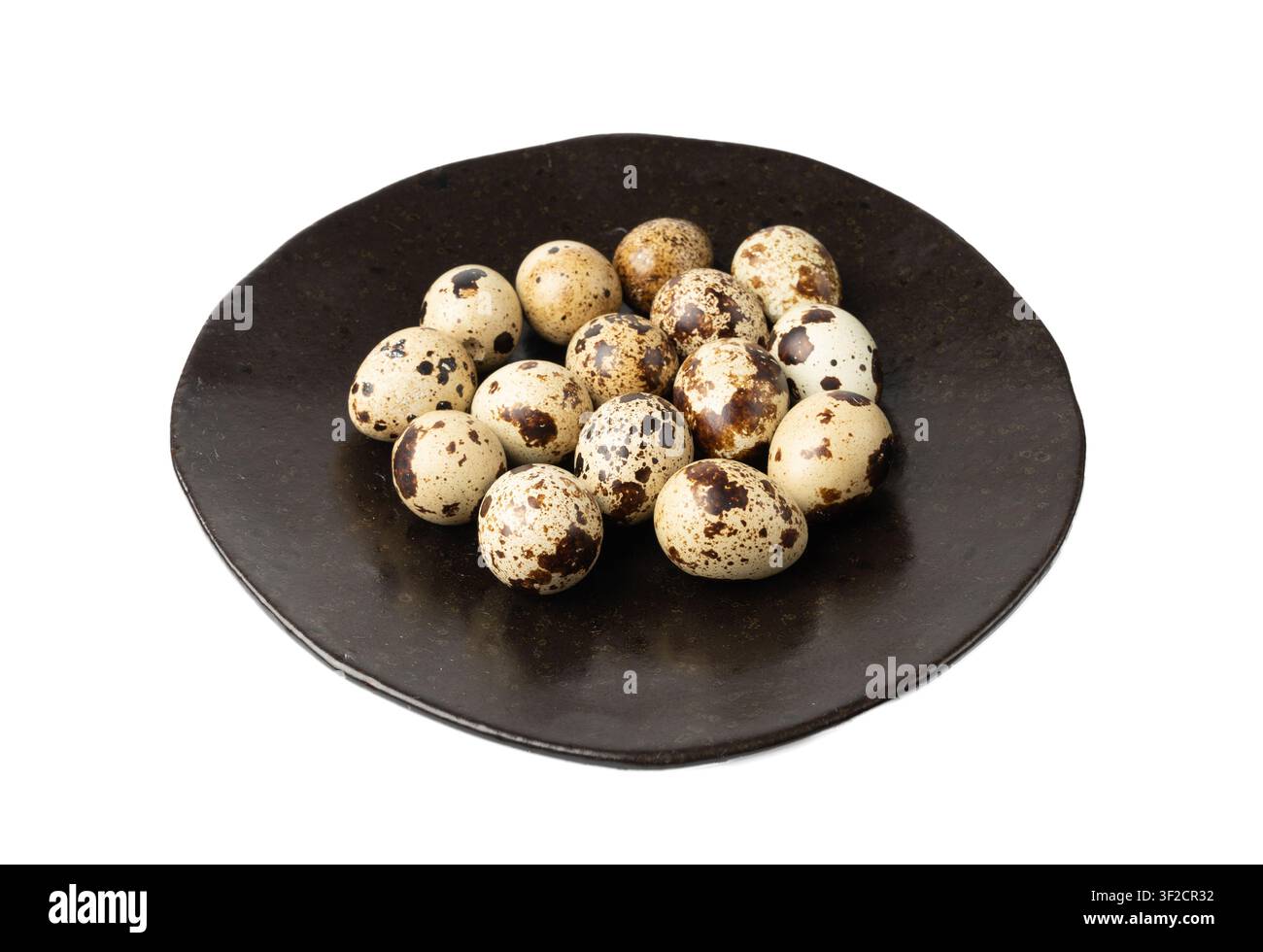 Quail Eggs Isolated, Diet Egg on Black Plate, Healthy Breakfast, Natural Organic Nutrition, Salad Ingredient Spotted Quail Egg on White Background Stock Photo