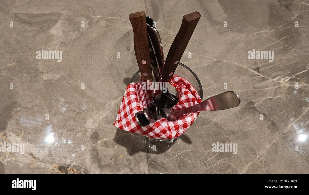 Complete dining utensil set arranged on a dining table. Stock Photo