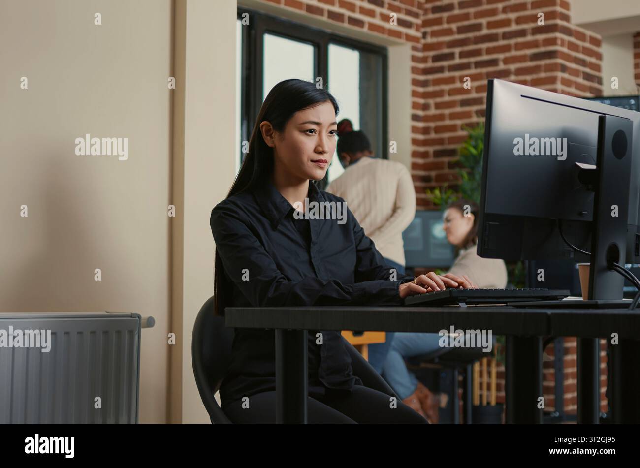 System Engineer Smiling After Successful Code Compile at a software development desk after compiling source code successfully, showing algorithm work and coding success. Stock Photo