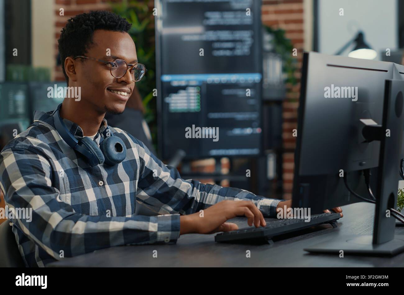 Portrait of software engineer coding software arranging glasses and being happy about parsing results around computer screens, showing developer teamwork, source code discussion and cloud. Stock Photo