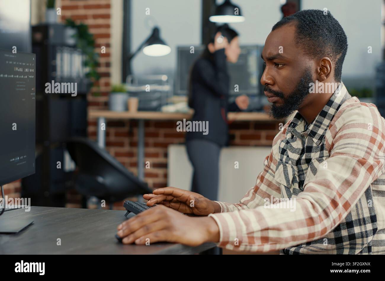 Static portrait of african american system engineer working concentrated reviewing computer screen around computer screens, showing developer teamwork, source code discussion and cloud programming. Stock Photo