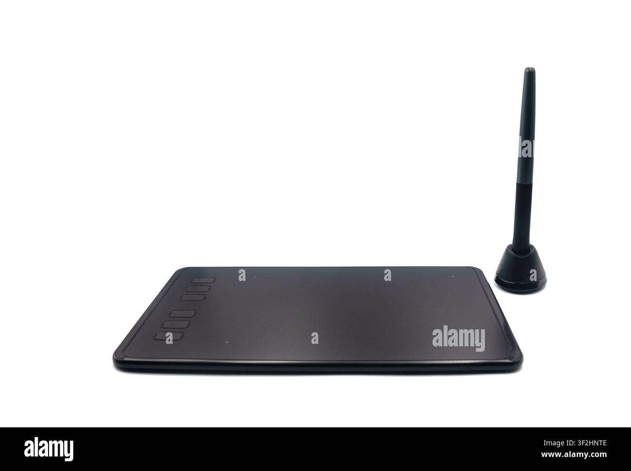 Black digital graphics tablet with a stylus on a white background Stock Photo