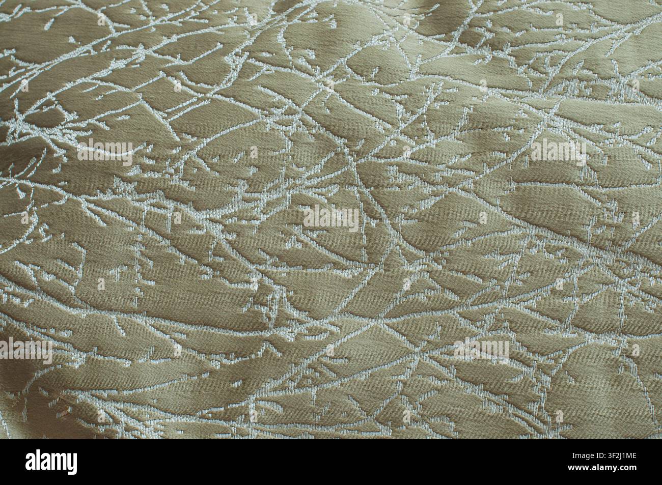 Elegant olive green jacquard fabric with abstract white branch pattern. Perfect for luxury interior and textile design. Stock Photo
