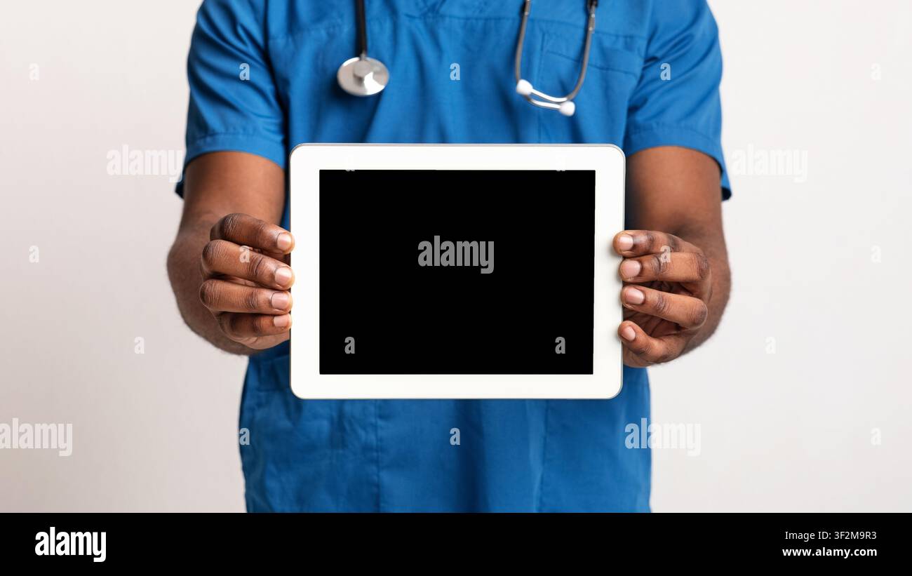 Empty digital tablet screen in black doctor hands Stock Photo