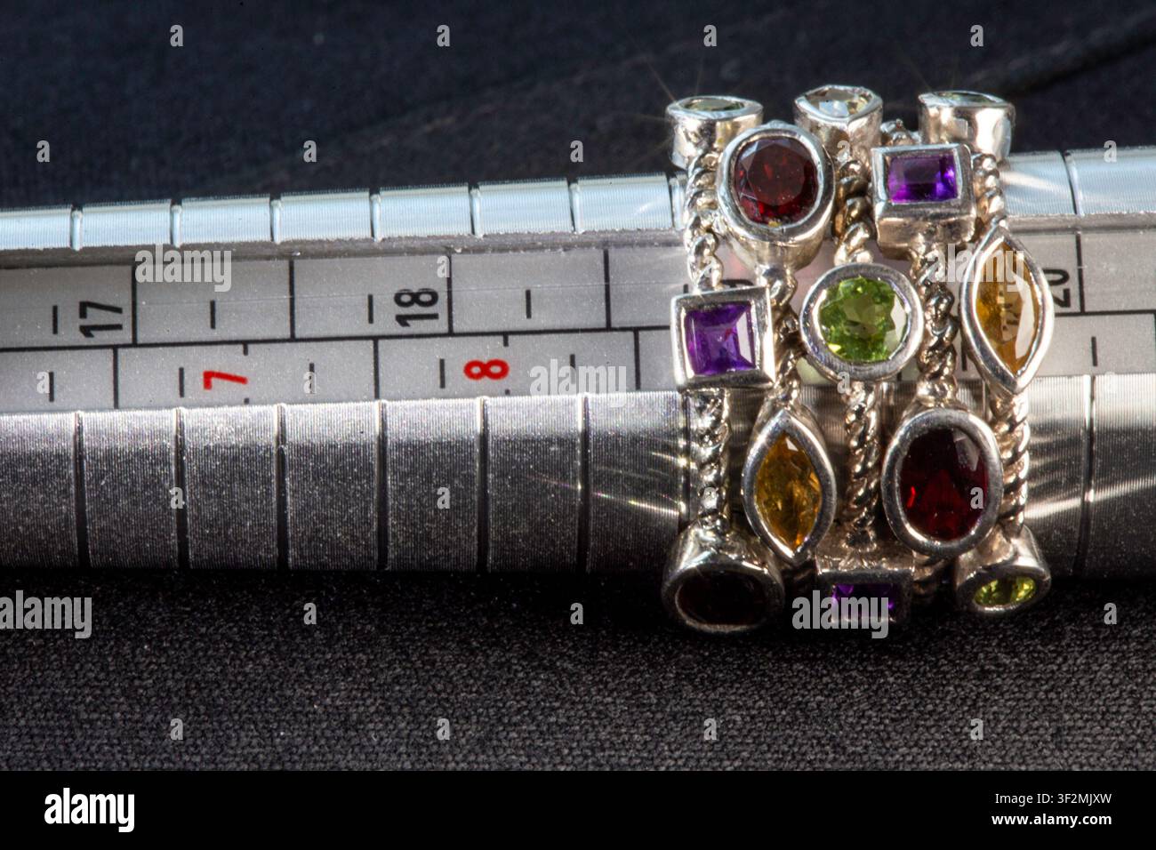 Vintage sterling silver multi-stone statement ring on sizing mandrel Stock Photo