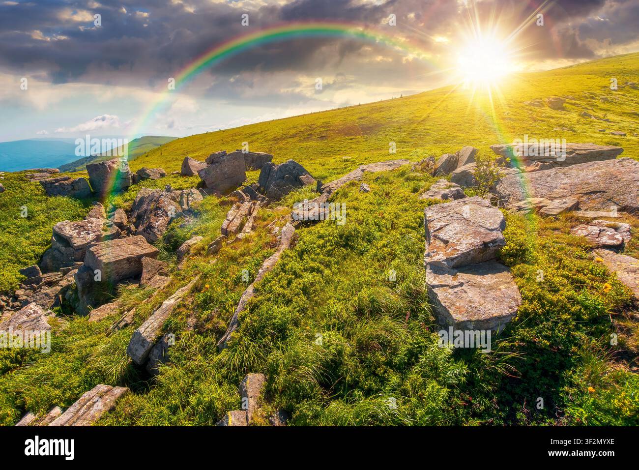 sunset over alpine grassy meadow. carpathian mountains landscape with huge boulders. alpine nature scenery of ukraine highlands in summer. view of rem Stock Photo