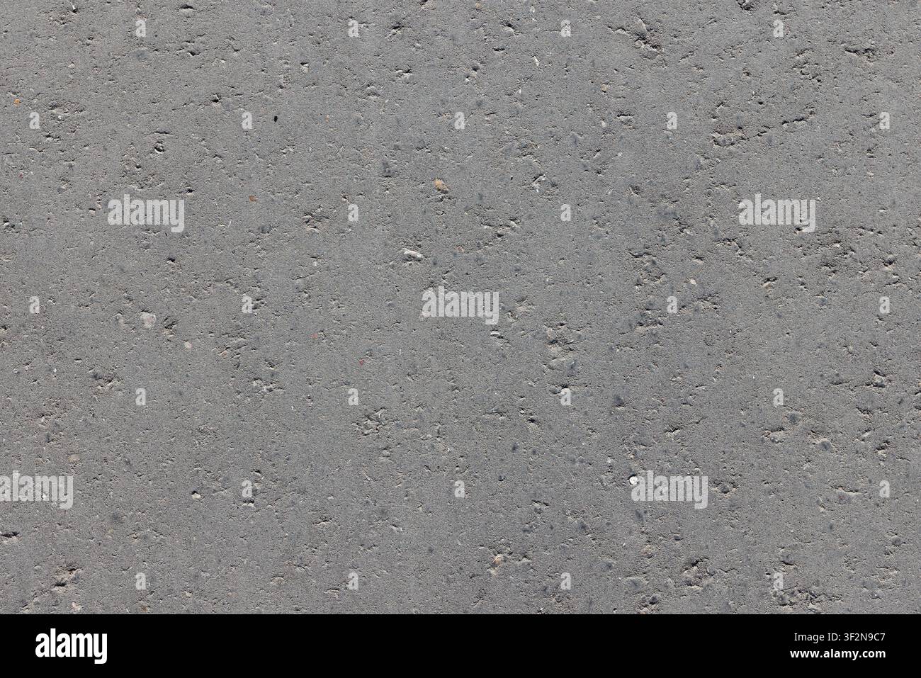 Flat gray asphalt texture showing close-up tarmac detail and uneven surface. Ideal background for road  construction and design projects and industria Stock Photo